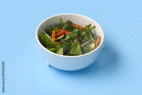 Bowl of fresh salad covered...