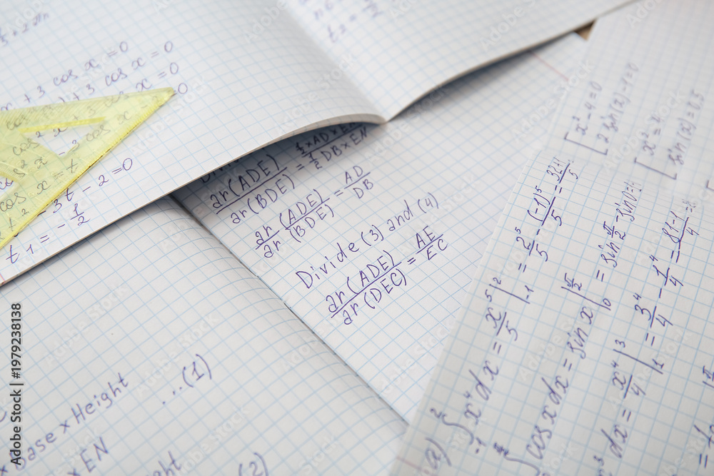 Naklejka premium Open copybooks with math formulas as background, closeup
