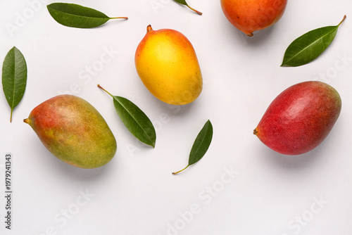 Fresh ripe mangoes on light...