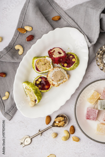 Plates with tasty Turkish delight on light background