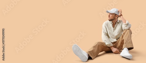 Stylish young man sitting o...
