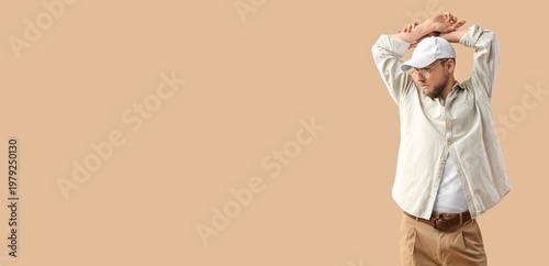 Stylish young man on beige ...