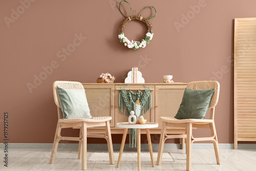 Interior of living room with Easter wreath, chairs and table