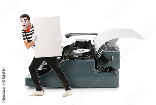 Bild auf Leinwand Male pantomimist with blank poster and big typewriter on white background