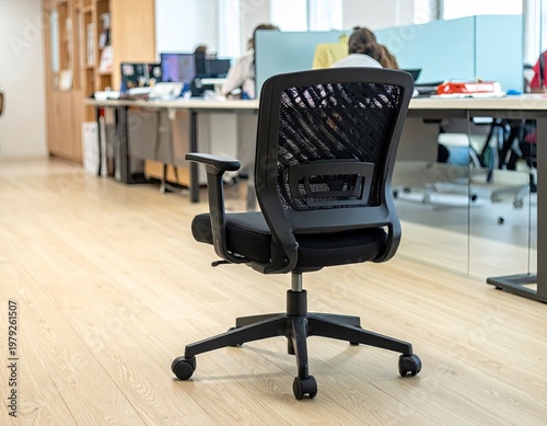 Black office chair centered in a bright, modern workspace