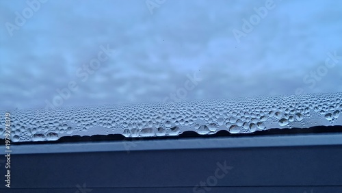 Obraz na płótnie Condensation water droplets on a window glass, wet surface background, home humi