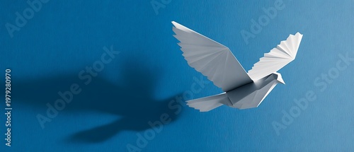 White origami paper dove flying on a blue textured background, symbol of peace and freedom