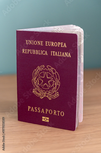 Wallpaper Mural Italian passport standing on wooden surface, showing travel and freedom Torontodigital.ca