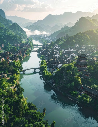 A breathtaking aerial view showcases a traditional Chinese village nestled within a lush, mountainous landscape, with a winding river gracefully flowing through the heart of the settlement.