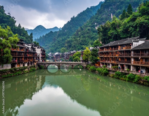 A picturesque view of a traditional Chinese village nestled amidst lush green mountains and a tranquil river, showcasing unique architecture and serene natural beauty.