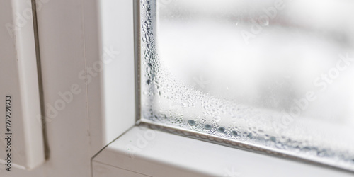 Cuadro en lienzo Window corner with condensation droplets on interior sill