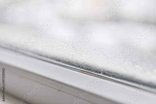 Photos Condensation on window pane with blurred outdoor background