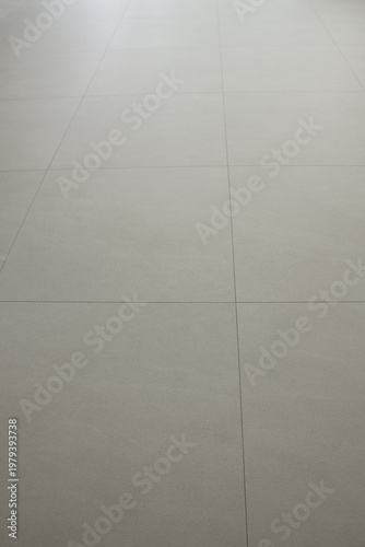 
The living room has a beige hardwood floor.