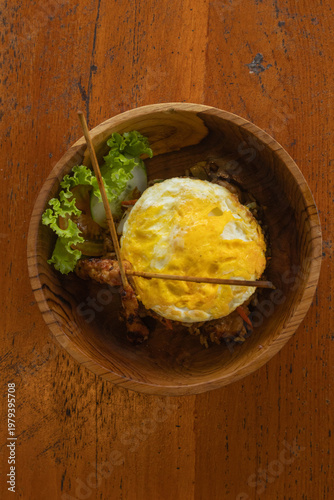 Authentic Indonesian Nasi Goreng fried rice with chicken satay and fried egg