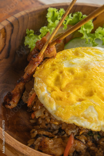 Authentic Indonesian Nasi Goreng fried rice with chicken satay and fried egg