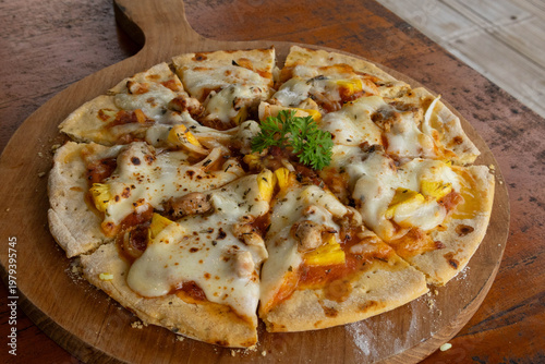 Close up macro of delicious baked pizza with melted cheese and pineapple