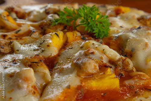 Close up macro of delicious baked pizza with melted cheese and pineapple