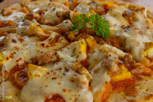 Close up macro of delicious baked pizza with melted cheese and pineapple