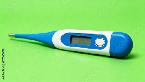 Blue and white digital thermometer isolated on green chroma key background with soft studio lighting, angled product closeup, healthcare monitoring concept, clean commercial stock reference