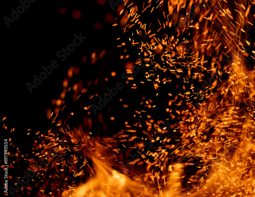 The image is of a fire with a lot of sparks flying out of it