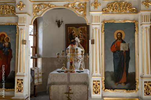 Foto Orthodox Church Interior with Golden Iconostasis and Priest Performing Baptism C