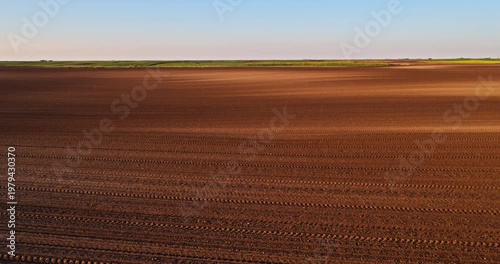 Aerial view of plowed farmland field ready for seeding