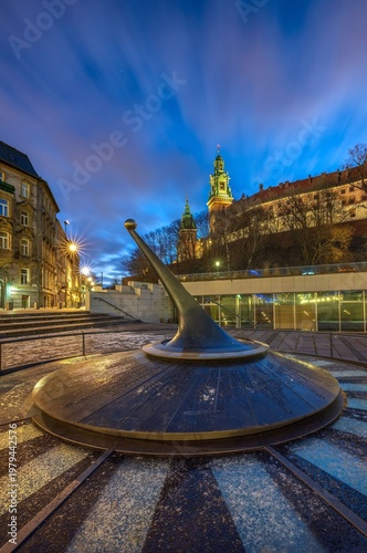 Modern sundial with Wawel Royal Castle at blue hour, Krakow, Poland