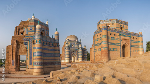Scenic landscape view of ancient graveyard before sunset with medieval landmark Bibi Jawindi tomb in middle, Uch Sharif, Bahawalpur, Punjab, Pakistan