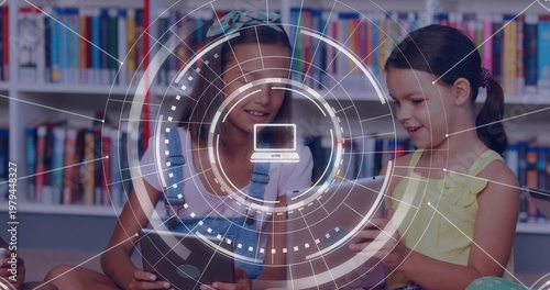 Two girls sitting on library floor tapping tablets and causing AR HUD overlay highlighting books
