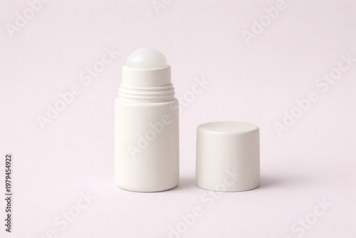 Minimalist white roll-on deodorant on soft pink background for product design