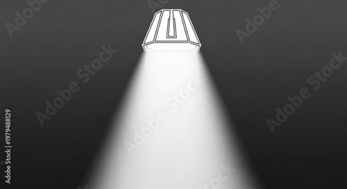 Spotlight shines bright beam of light from sleek metal lamp on dark background