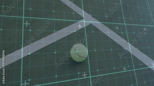 Chartreuse tennis ball resting on dark court, showing green digital grid overlay tracking position