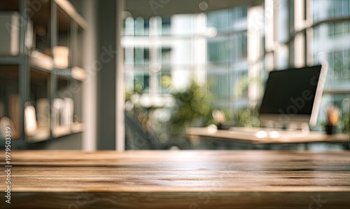 Empty wooden table surface, blurred modern office interior with computer in background