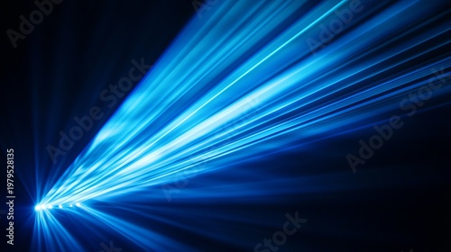 A bright blue laser beam shining in a dark room with a black background