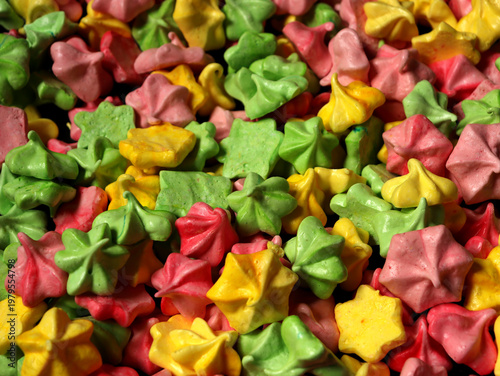 Colorful meringue treats displayed in a bright assortment at a local market during a sunny afternoon