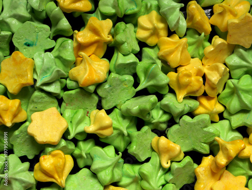 Colorful meringue shapes arranged on a tray for a dessert display at a baking event near the local park during spring