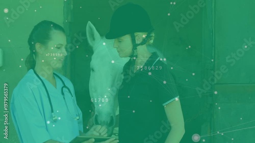 Vet tapping tablet, explaining exam results for horse health to rider, horse nudging between them