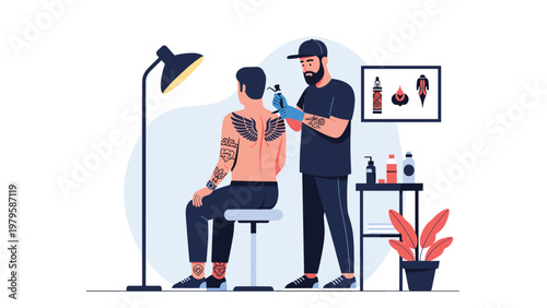 Professional tattoo artist wearing cap and gloves creating intricate wing design on man back in creative studio.