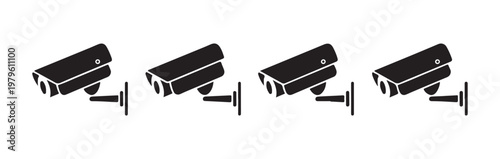 Four surveillance cameras mounted on walls, providing security and monitoring services outdoors.