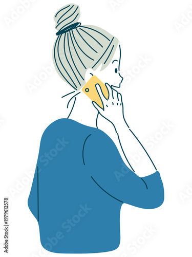 スマホで通話中の女性（横姿／シニヨンヘア）