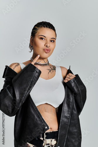 Stylish young woman expresses confidence in trendy outfit against minimalist backdrop