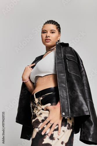 Young stylish woman showcases bold fashion in a modern urban setting during vibrant daylight