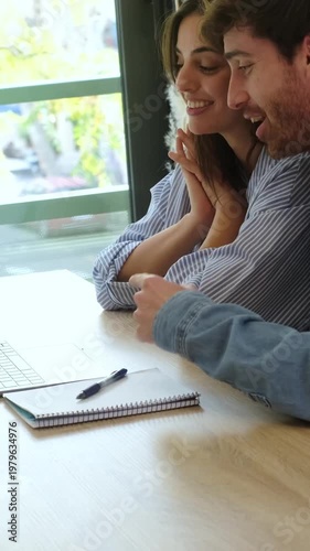 Young Couple Happily Engaged in a Virtual Chat, Sharing Laughter and Moments Together Online