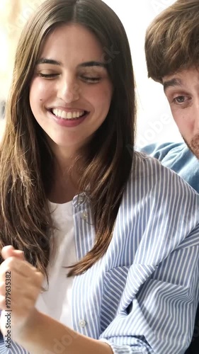 Happy Young Couple Engaging in a Cheerful Video Call Together, Sharing Joyful Moments