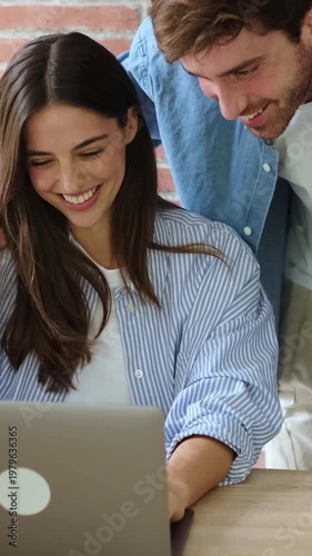 Happy Couple Sharing Joyful Moments And Laughter While Using A Laptop Together