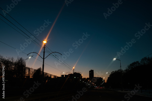 Anamorphic shot of city lights on street at night