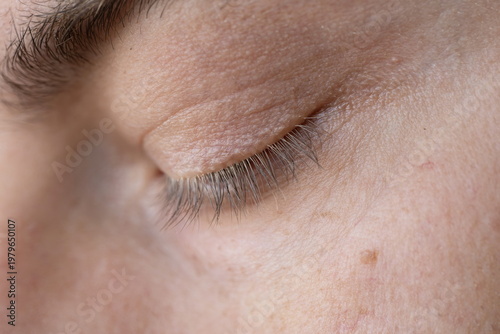 Tableau sur toile Macro close-up, detailed profile view of a male face with closed eyes featuring