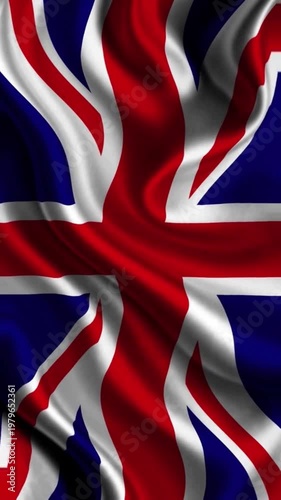 Wavy silk fabric texture of the United Kingdom Union Jack flag with realistic light reflections.
