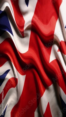 Close up of the United Kingdom flag with dramatic fabric folds and soft cinematic lighting.