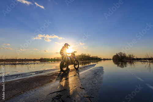 Wallpaper Mural Motorcyclist rides through reflective water at sunrise Torontodigital.ca